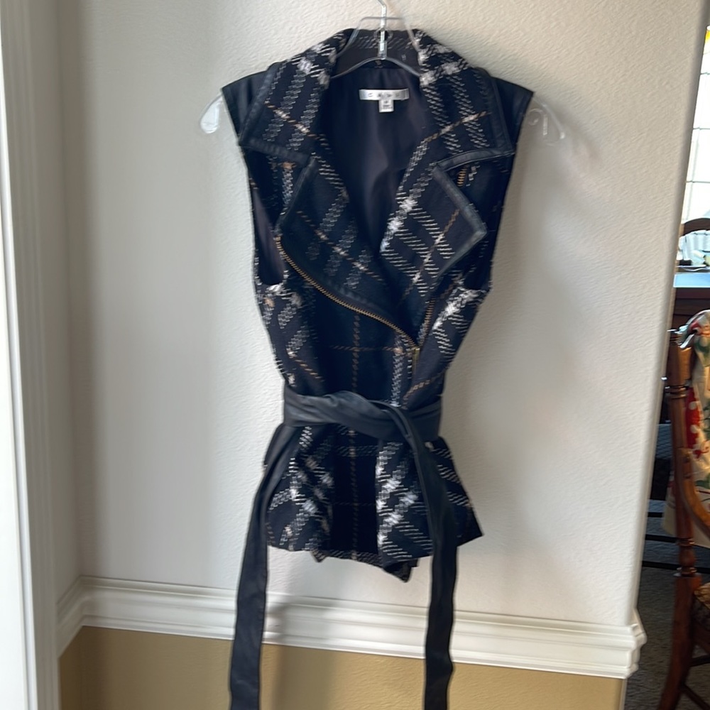 CAbi asymmetric zip vest with faux leather belt and leather piping.
